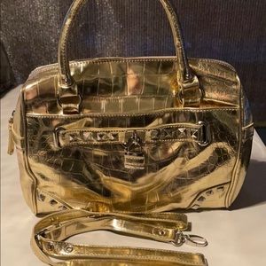 Nine West women handbag with shoulder
strap in color gold with studs $100
